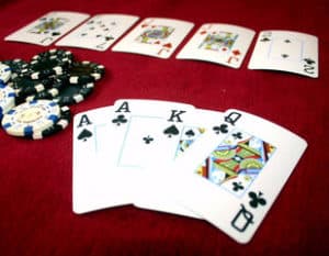 omaha poker open hand of four cards showing two aces, king and a queen