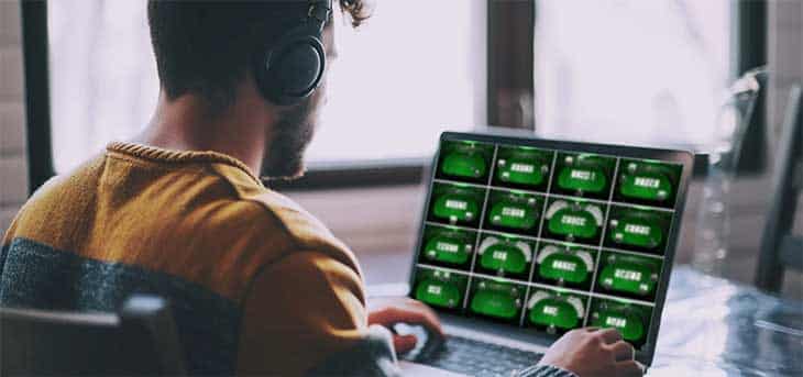 man at computer playing multi-table poker